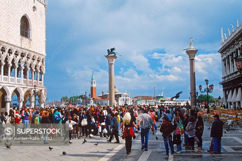 People and pigeons on Piazza San Marco or St. Marks Square in Venice Italy
