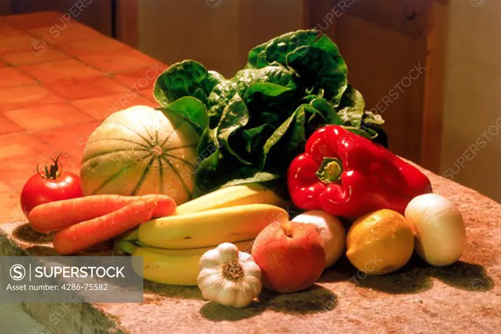 Variety of colorful vegetables on counter in country home kitchen