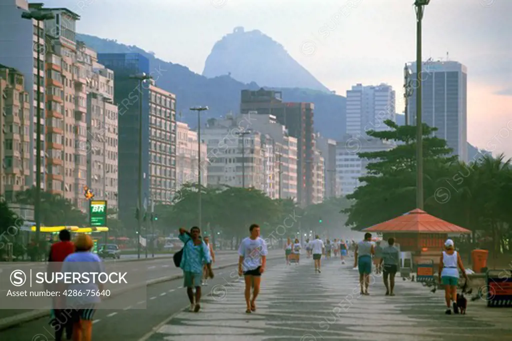 People taking morning walk along Copacabana Beach in Rio de Janeiro Brazil