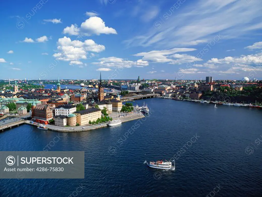 Overview of  Stockholm from Town Hall tower with ferryboat leaving Riddarholmen island on the Riddarfjarden