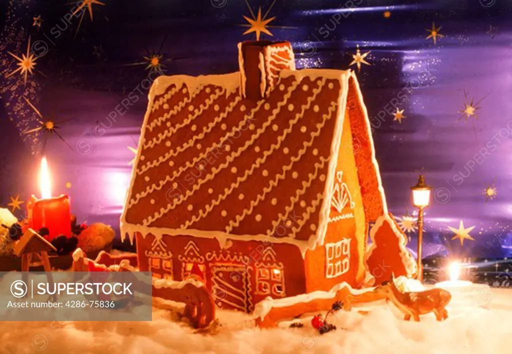 Home made gingerbread house with candles during Christmas Season