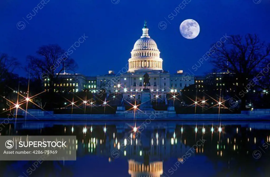 Capitol Building in Washington D C under full moon at night