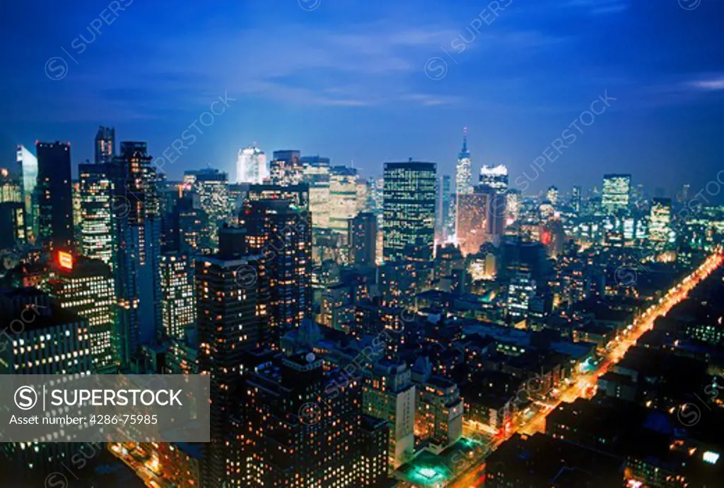 Upper Manhattan skyline above Central Park with Empire State Building at night