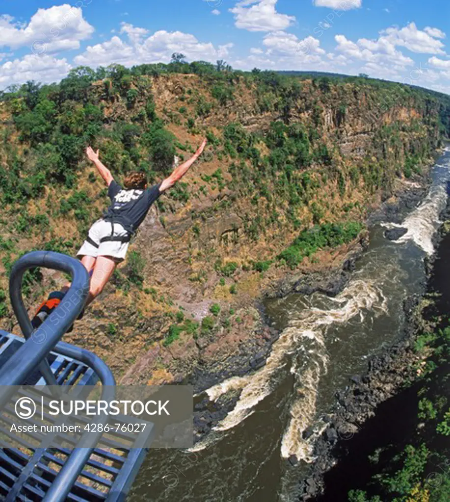 Bungy jumping off 152 meter high Victoria Falls Bridge above Zambezi River between Zimbabwe and Zambia.