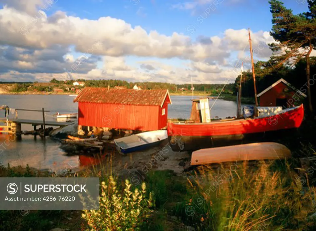 Red boat and boathouse near town of Stromstad Strmstad on West Coast of Sweden