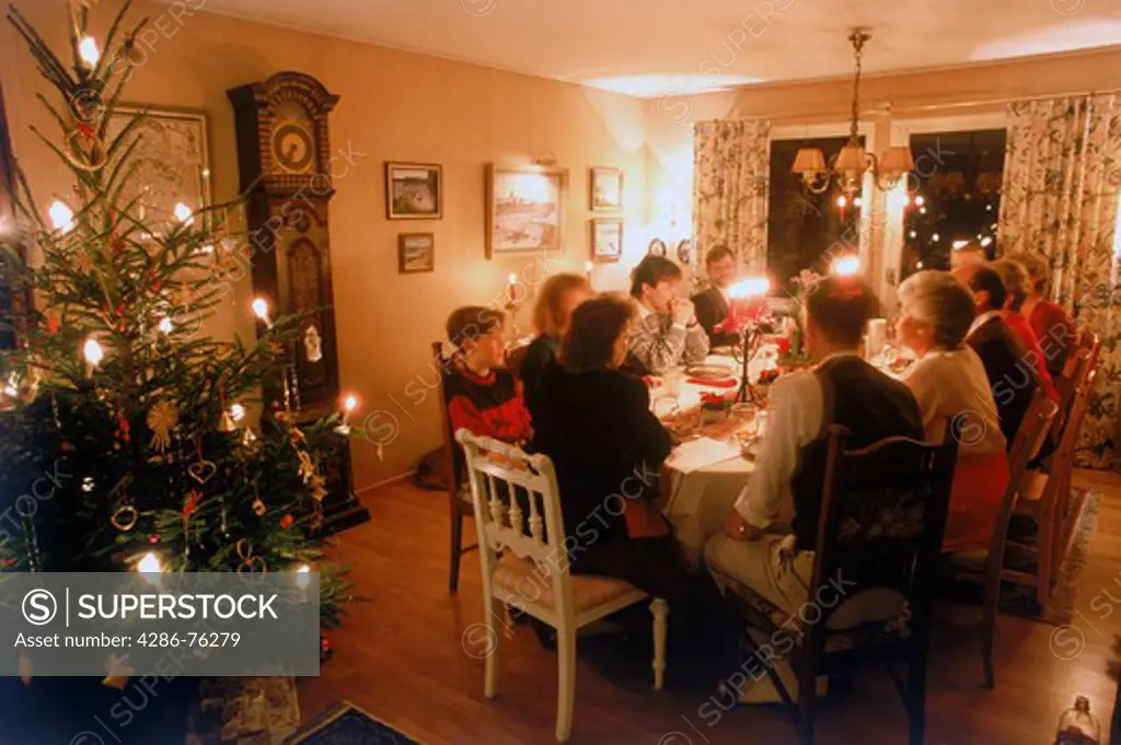 Family sharing warm Christmas dinner at home in Sweden