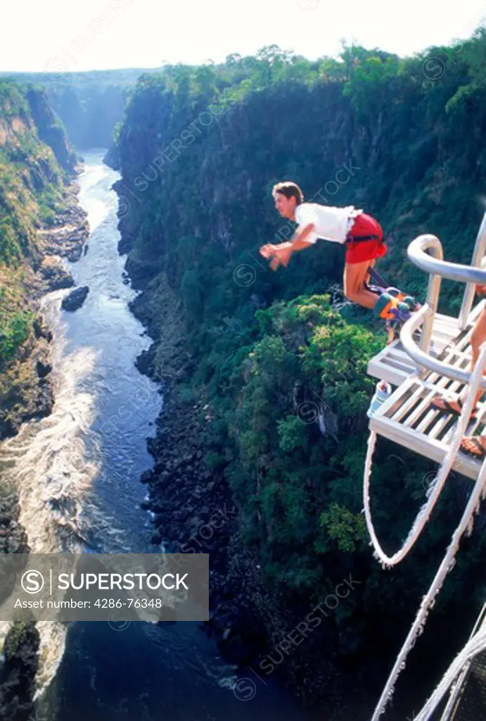 Bungy jumping off 152 meter high Victoria Falls Bridge above Zambezi River between Zambia and Zimbabwe