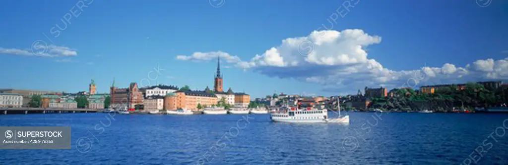 Ferryboat on Riddarfjarden waters with Riddarholmen Island behind in Stockholm