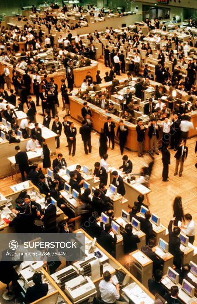 Brokers standing on floor of Tokyo Stock Exchange