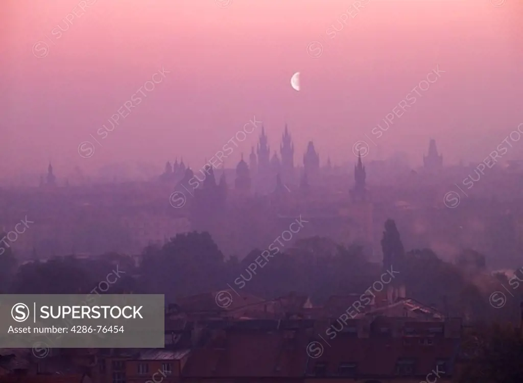 Moon over 'City of 100 Steeples' with St Vitus Cathedral and Hradcany Castle at dusk in Prague