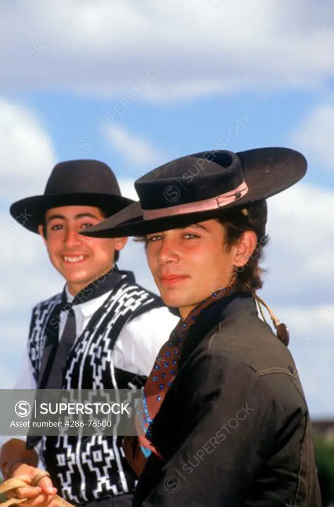 Young gauchos on horseback with hats in Argentina