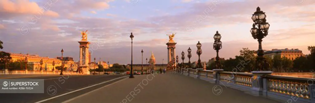 Pont Alexandre III and Hotel des Invalides at sunset in Paris