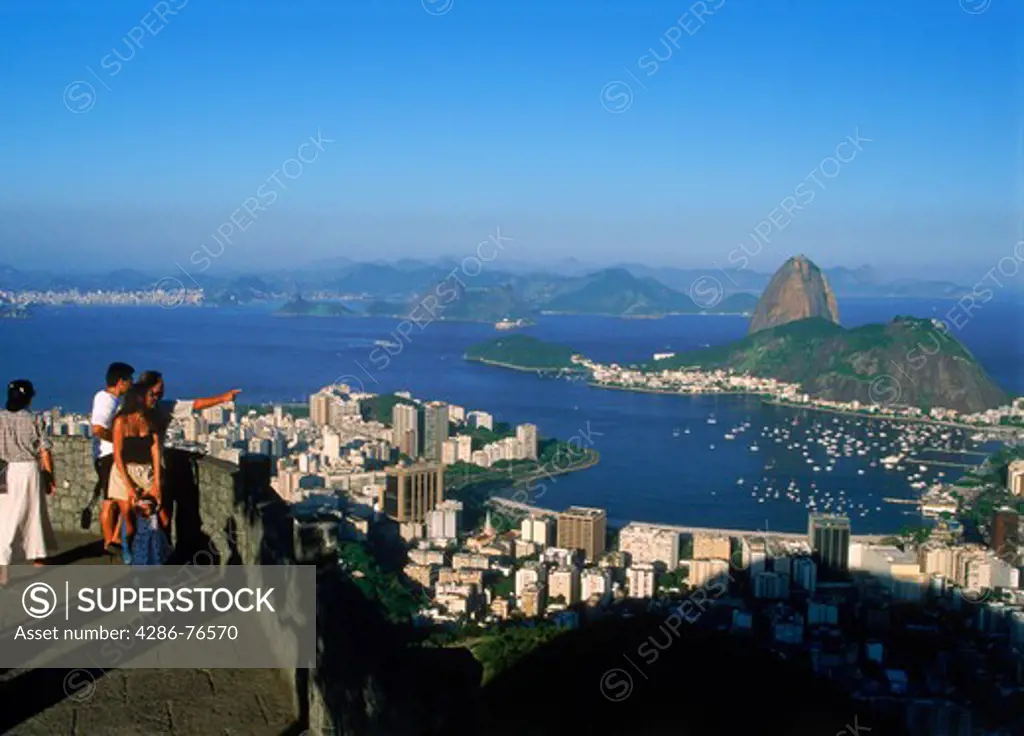 Day visitors at lookout point on Corcovado mountain above Pao de Acucar and Botofago Bay in Rio De Janeiro
