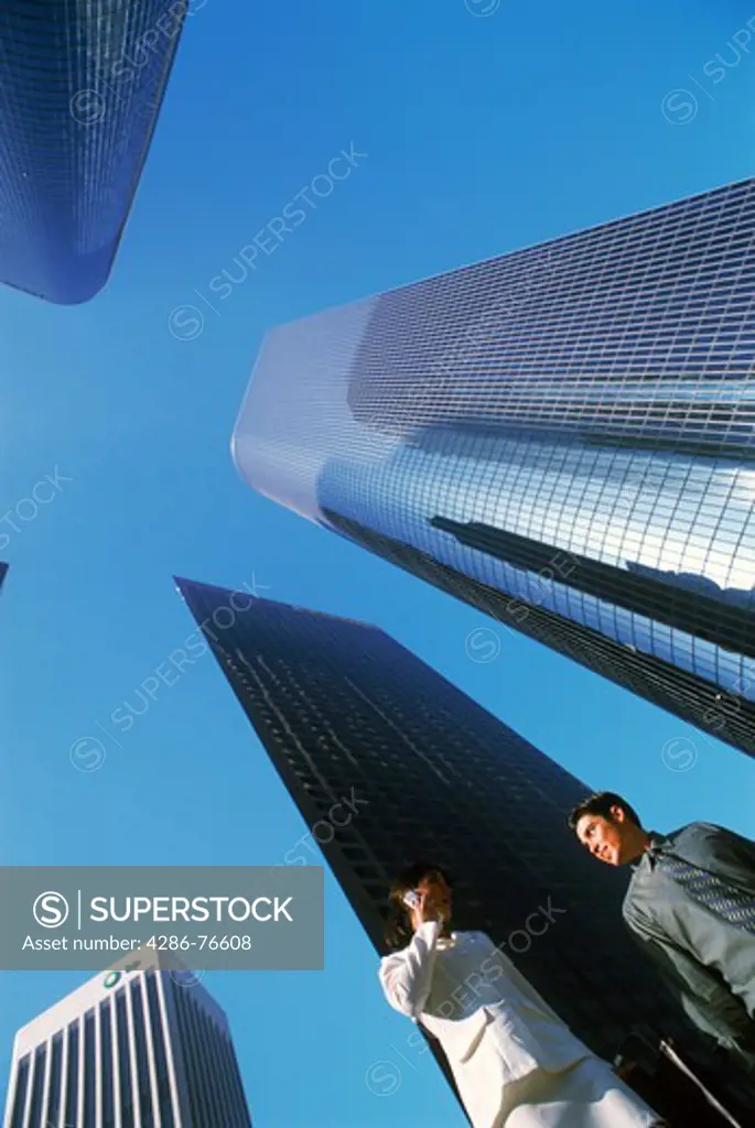 Businessman and woman under downtown Los Angeles Civic Center skyscrapers