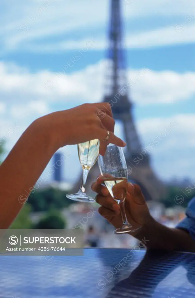 Man and woman toasting with glasses of champagne at Palace de Chaillot restaurant in Paris near Eiffel Tower