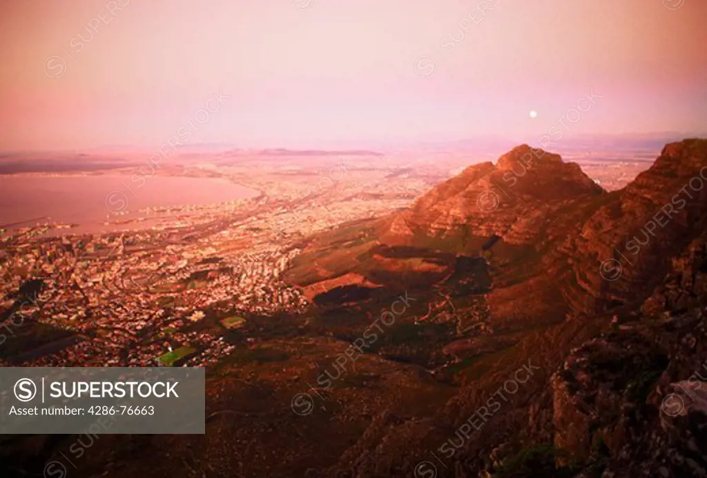 Moon over Cape Town and Table Bay at twilight from Table Mountain, South Africa