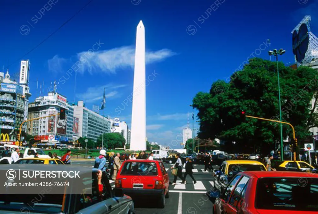 Car and foot traffic at crosswalk on  Avenida 9 de Julio near Obelisko in Buenos Aires