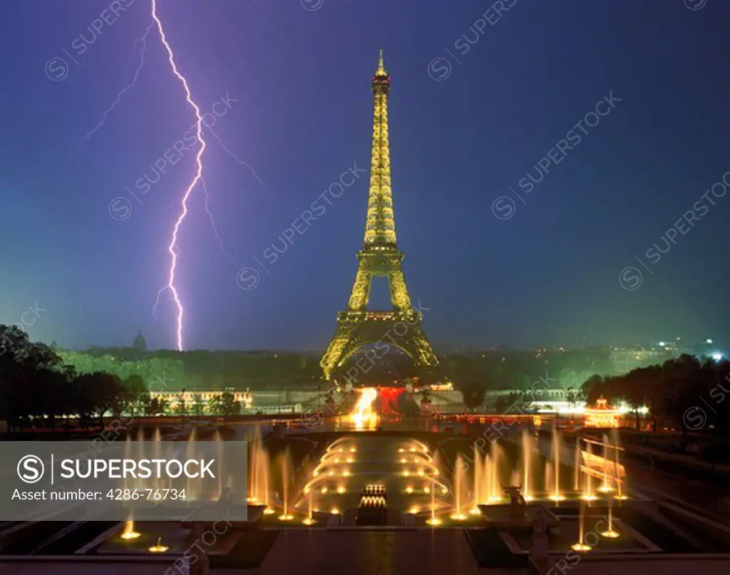 Lightning bolt and storm over Paris at night with Eiffel Tower and Palais de Chaillot  fountains