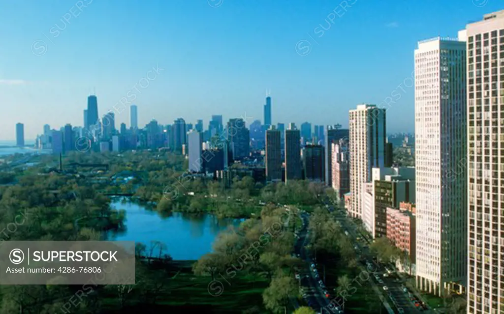 Chicago city skyline over park and lake with high rise apartment buildings