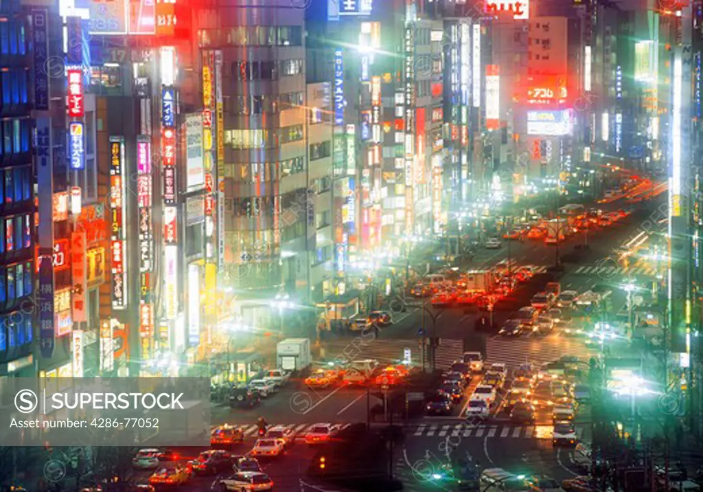 Neon lights and busy streets in Shinjuku District of Tokyo at night