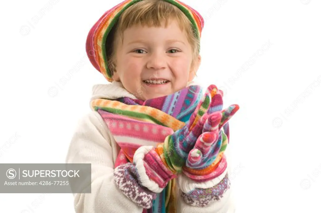 Little girl wearing colorful winter clothes, white background