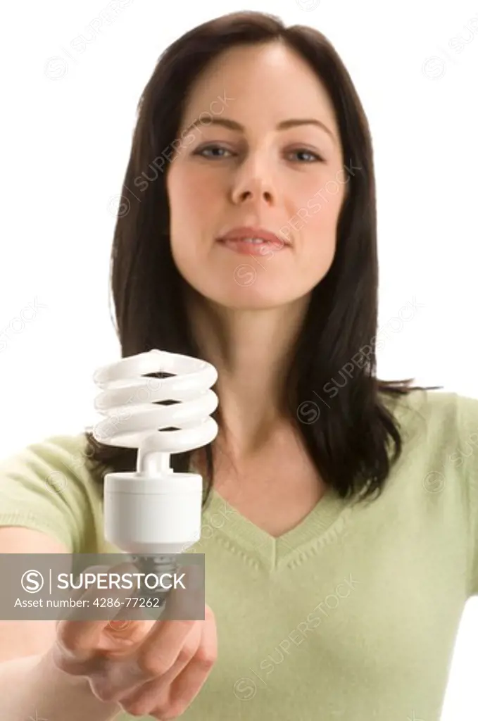 Studio portrait of woman holding a compact fluorescent lightbulb