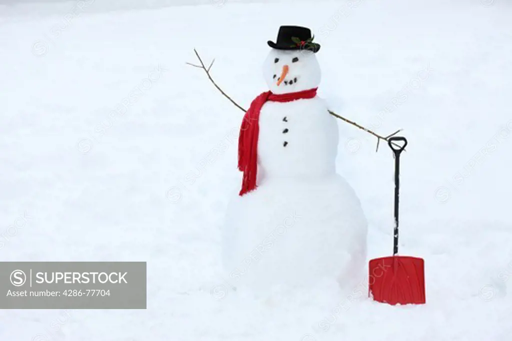 Snowman with shovel in hand