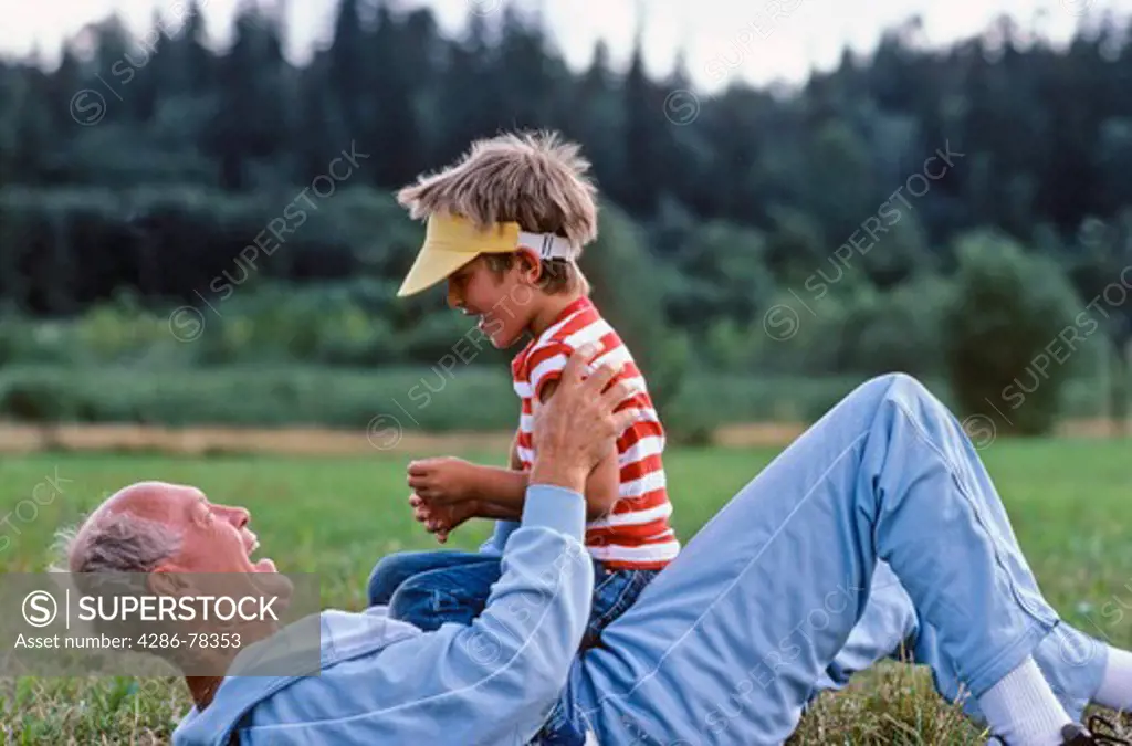 BOY AND GRANDFATHER PLAYING.