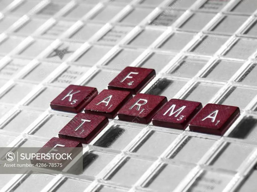Individual tiles with letters spelling out the words karma and fate.