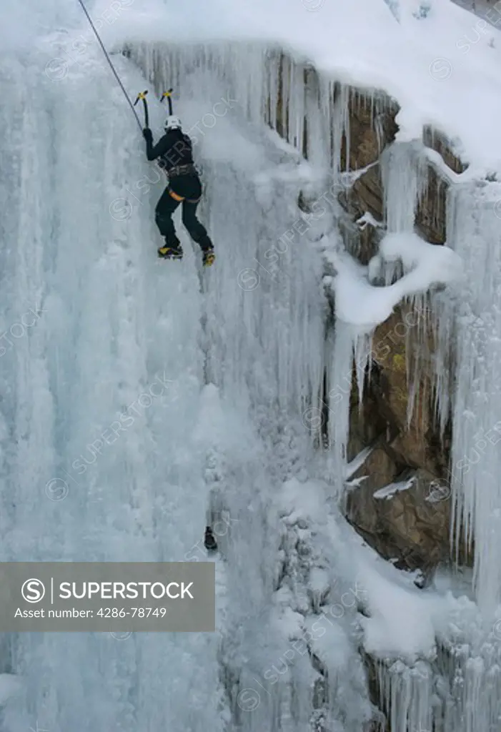 Woman ice climbing in Box Canyon, Ouray, Colorado