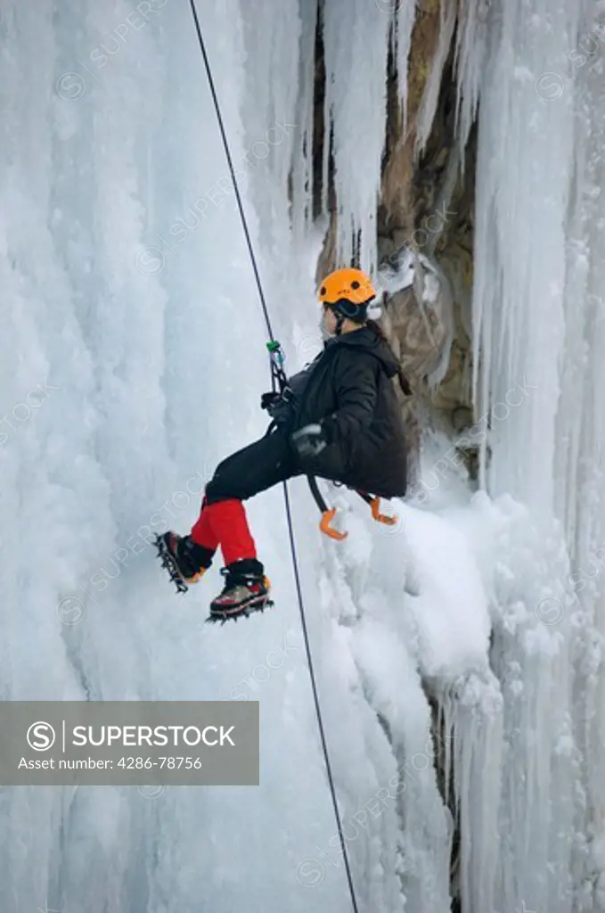 Woman repelling ice cliff in Box Canyon, Ouray, Colorado