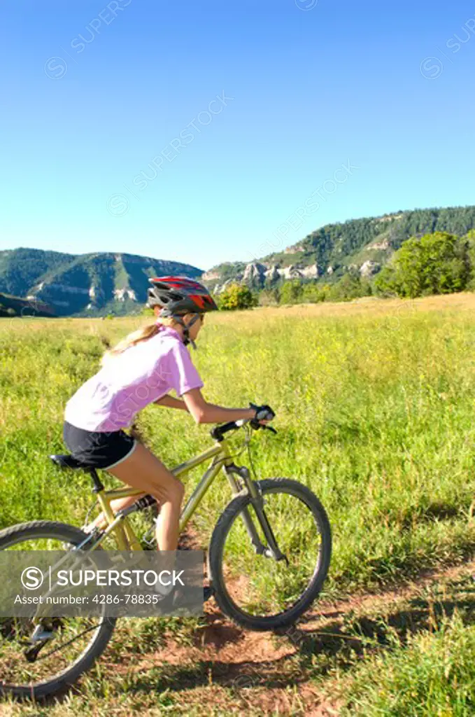 Pre-teen girl mountain biking