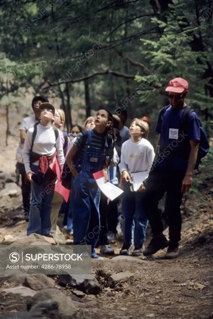 5th Graders study ecosystems during guided hike in the Sanda Mts. recording observations and data for written reports. / Sandia Environmental Educational Outdoor Classroom, Sandia Mountains, Abq, NM
