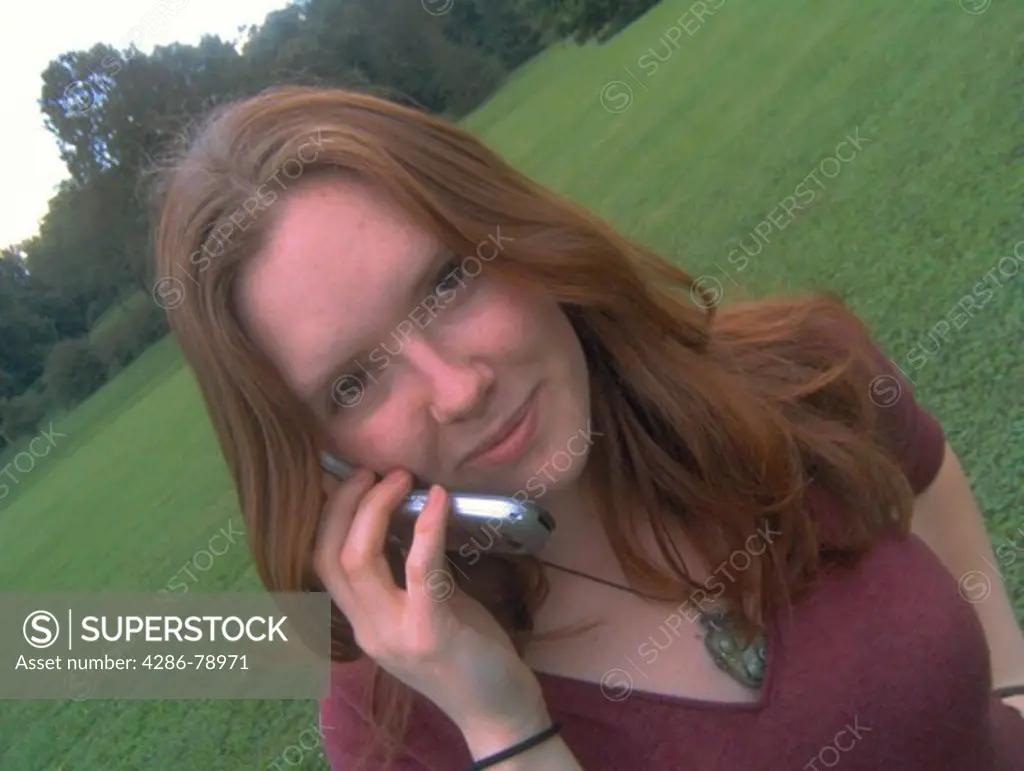 Attractive auburn haired woman on her cell phone at Earlham college, Indiana