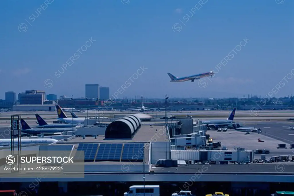 Airplanes taxing on the runways and taking off at LAX Airport, Los Angeles, CA