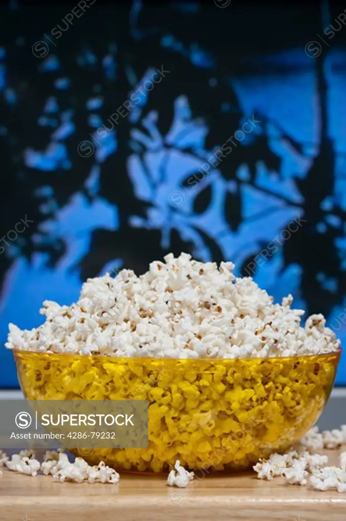 Watching home movies on the TV with a bowl of popcorn on a tv tray in the living room family entertainment
