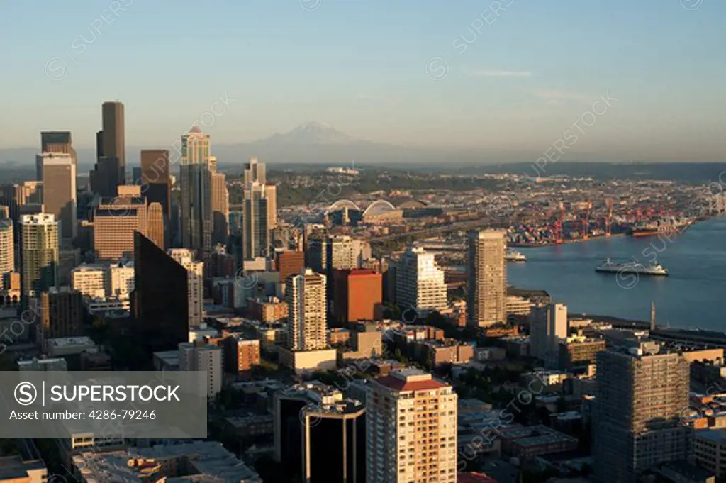 Seattle Skyline from Space Needle with Mount Rainier and downtown building and Ferry boats in Elliott Bay at sunset Seattle Washington State USA