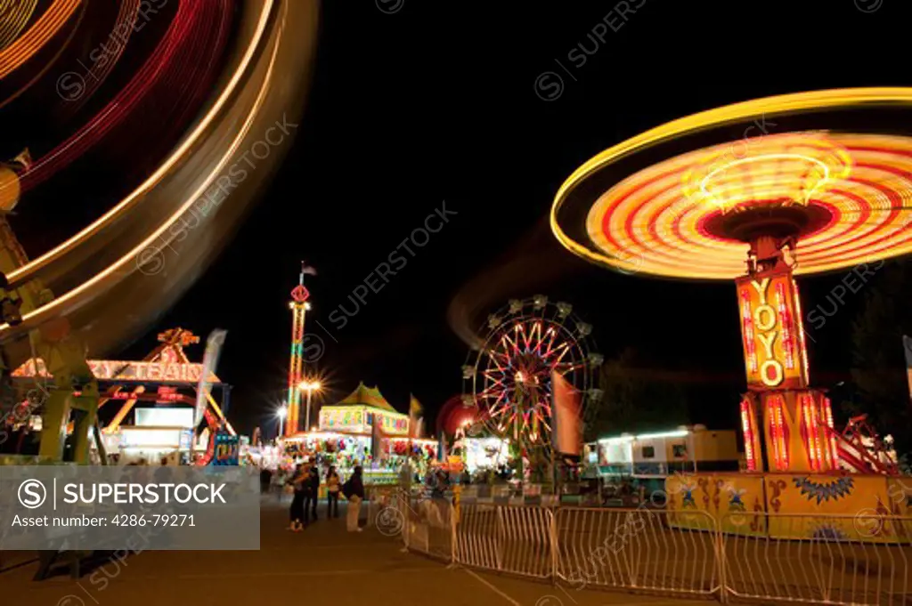 Evergreen State Fair people enjoying the amusement rides and game booths at night Monroe Washington State USA