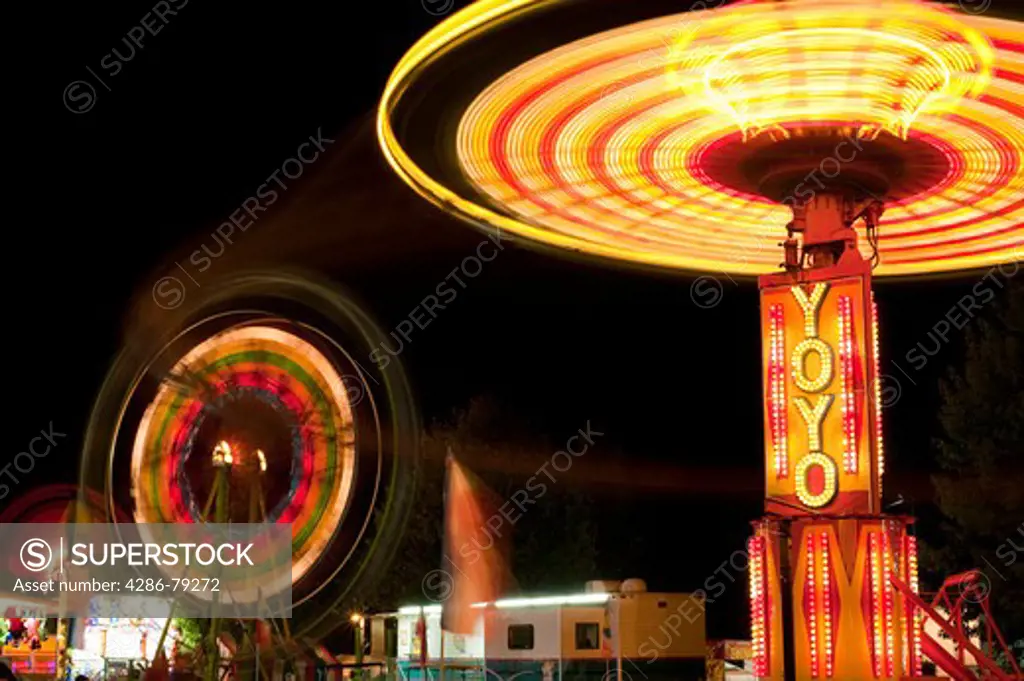 Evergreen State Fair people enjoying the amusement rides and game booths at night Monroe Washington State USA