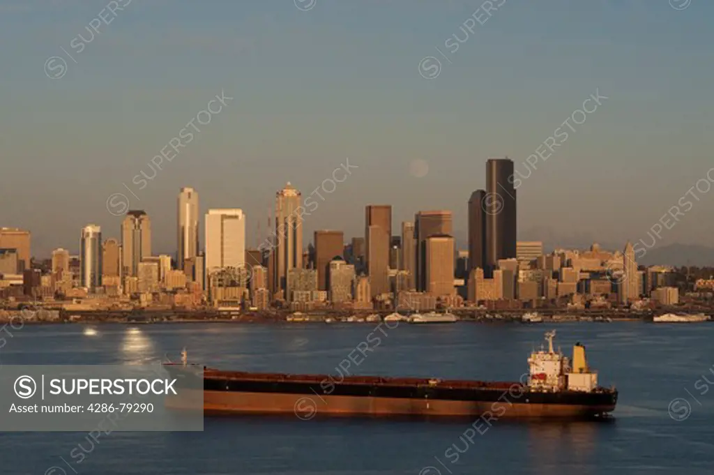 Seattle Skyline from West Seattle overlooking Elliott Bay with tankers in Bay at sunset with moonrise Seattle Washington State USA