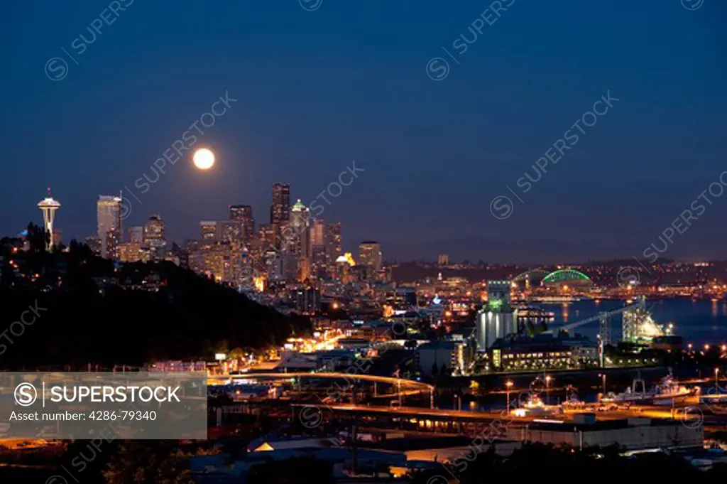 Moonrise from Magnolia Bluff Seattle Skyline at twilight with Space Needle and Port of Seattle Seattle Washington State USA