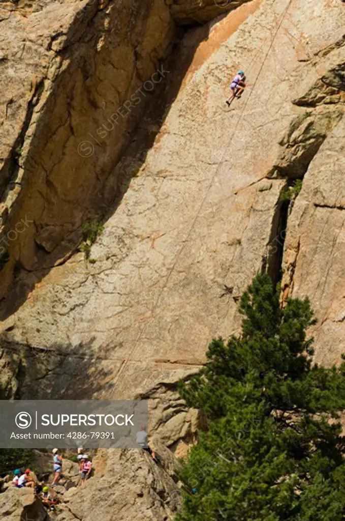 Teen kids climbing Christmas Rock at Cheley Camp, summer, Estes Park, Colorado, not released