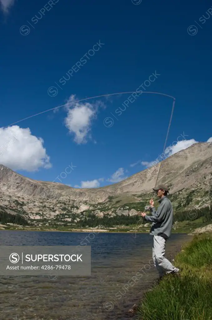 Man fishing during a summer morning at Lawn Lake in Rocky Mountain National Park, Colorado, USA