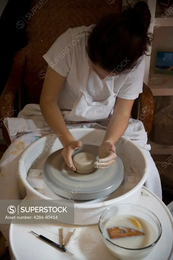 Girl on pottery wheel