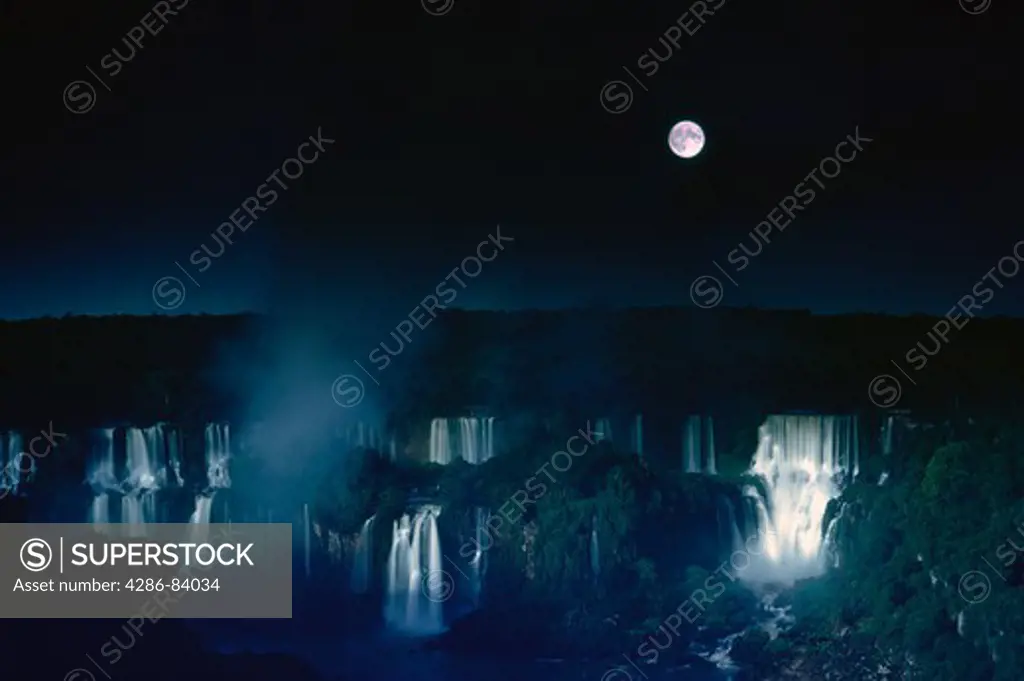 The moon over Iguazu Falls, located on the border of the Brazil, Argentina & Paraguay.