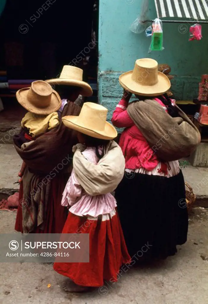 Women and child, natives of Cajamarca, Peru, wear hats typical of the region.