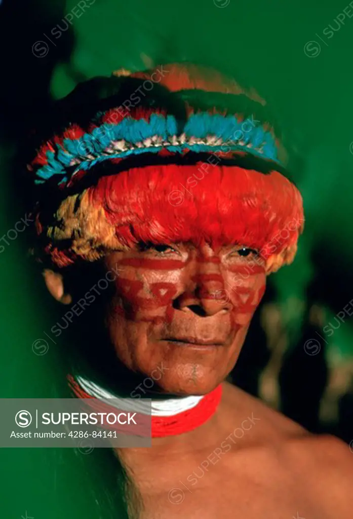 Portrait of Achual tribe chief wearing feather headdress; southern Ecuador / northern Peru