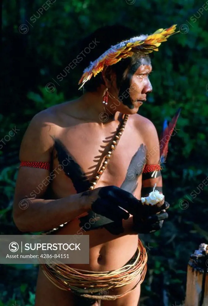 Urueu-Wau-Wau Indian warrior eating manioc in Rondnia, Brazil