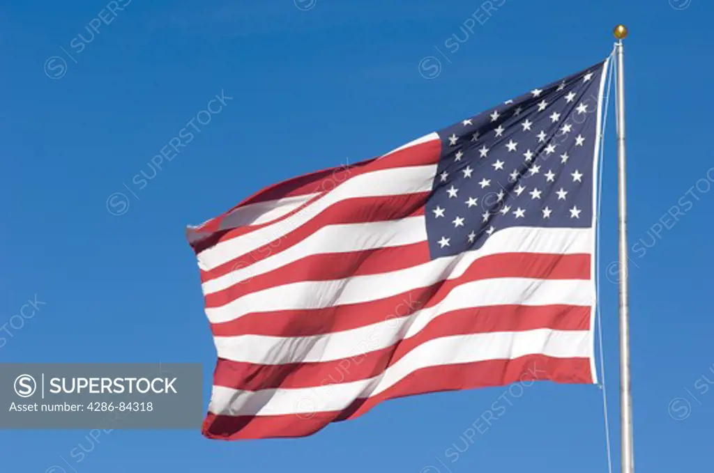 The American flag blows in the breeze.