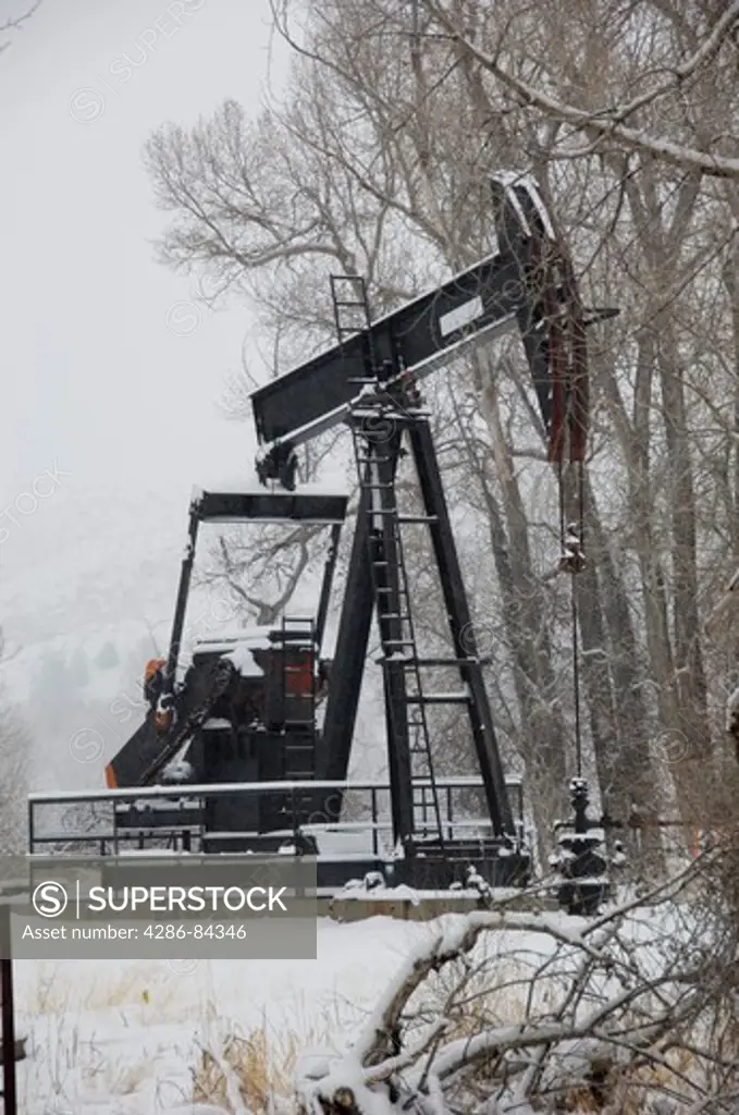 Oil and gas pumper in Wyoming winter.